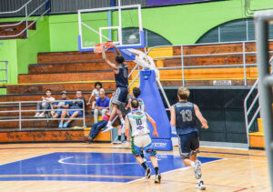 image of Jasai Miles UNF basketball player dunking